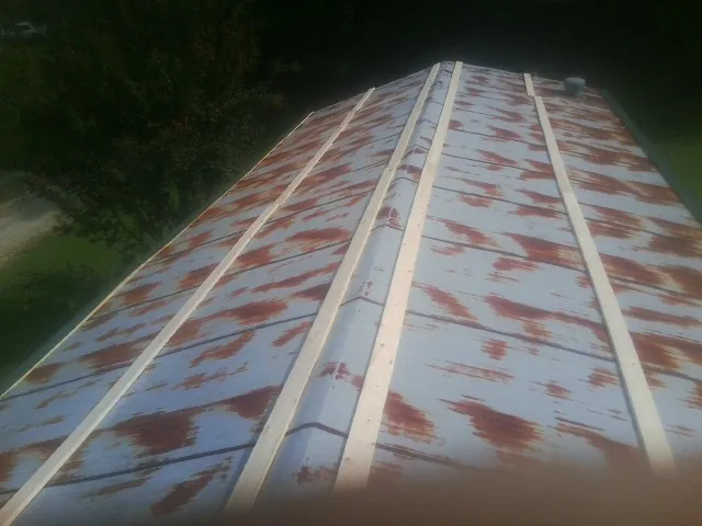 Rusted metal roof panels with new wood purlins before replacement — Storm Damage Roof Repair in Rayle by Roofing Brothers