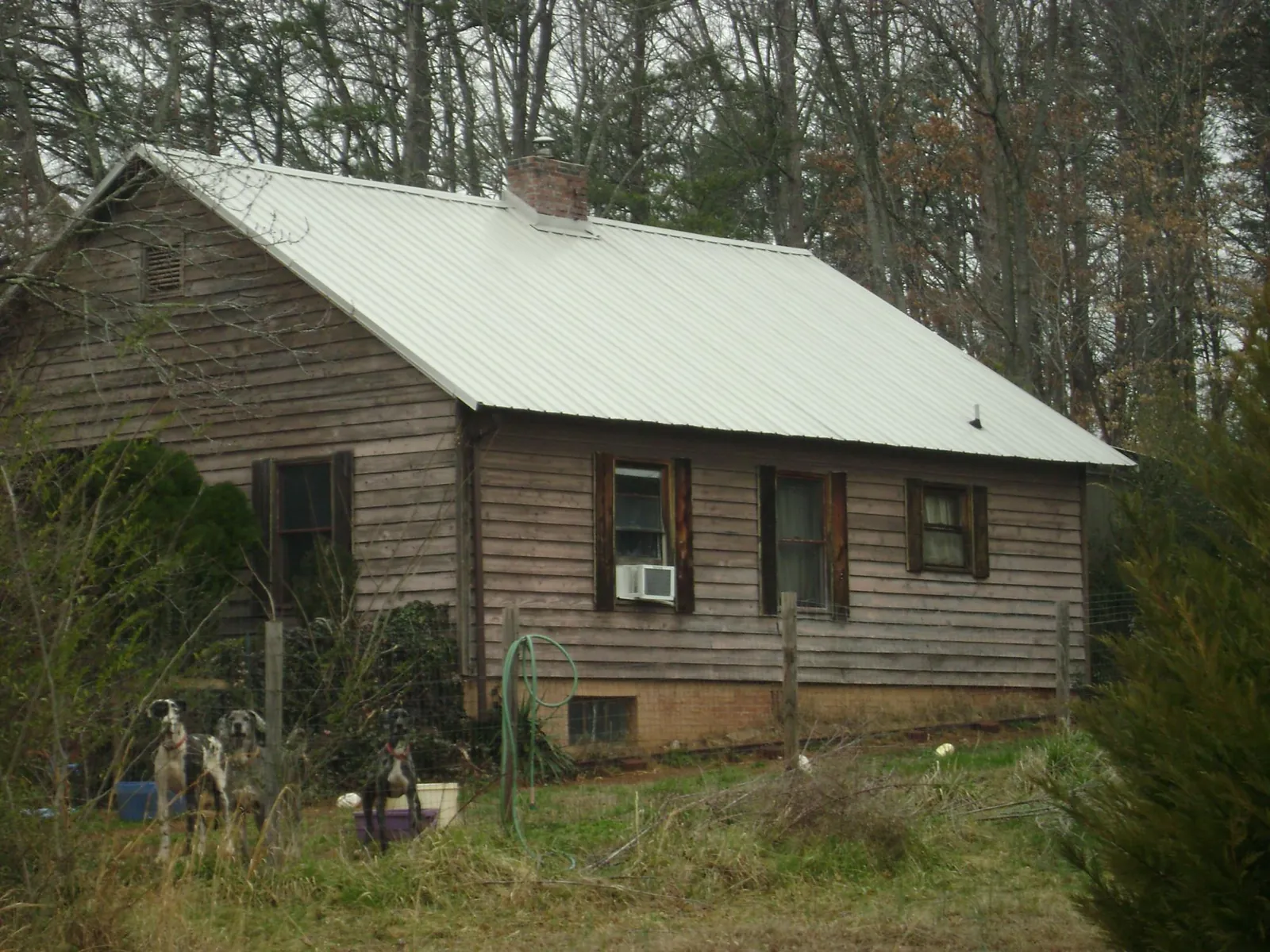 White metal roof on an old wood sided farmhouse, from a Metal Roof Installation job in Rayle